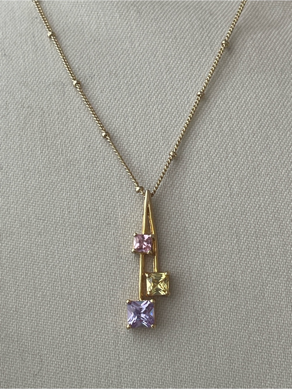 16” gold-tone station necklace with pink, yellow and lavender CZs pendant
